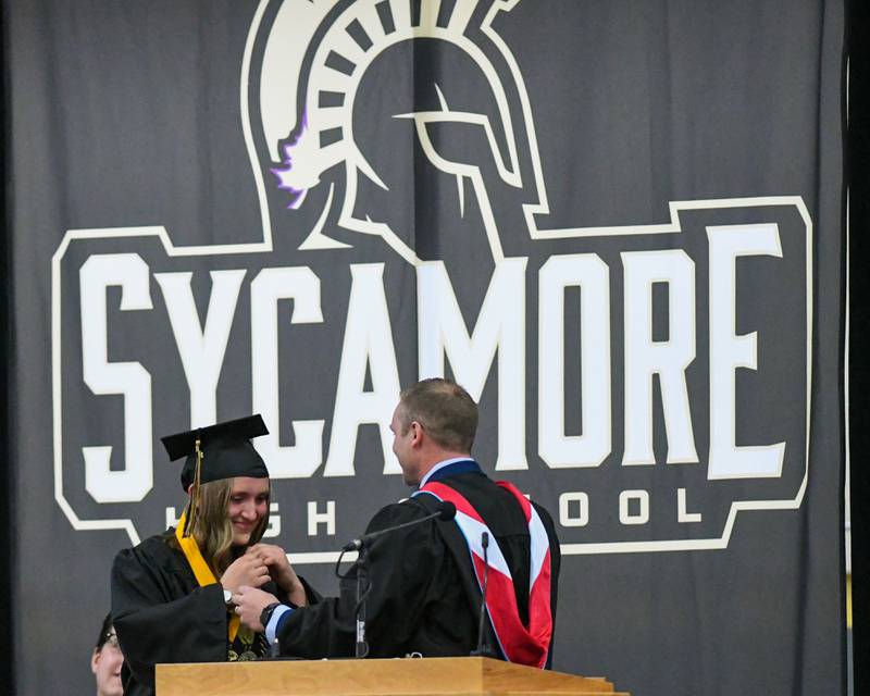 Sycamore High School Principal Brian Swanson gives valedictorian and graduating senior Elizabeth McConkie a medal on Sunday, May 25, 2025, during the Class of 2025 Commencement ceremony at the high school.