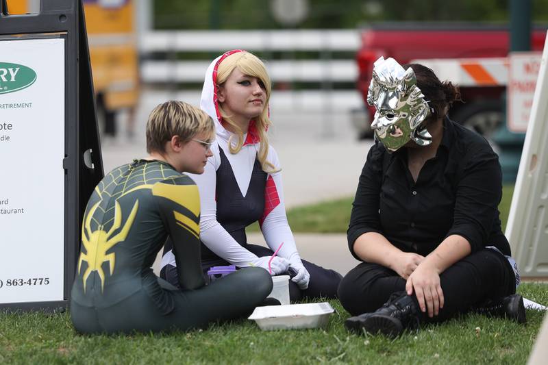 Clay Blasier, left, and Tenya Langhled, dressed as characters from Marvel’s Spider-verse, along with Niki Compton take a break at Comicolopis, Lockport’s 7th annual Comic and Fandom Con on Saturday, July 29.