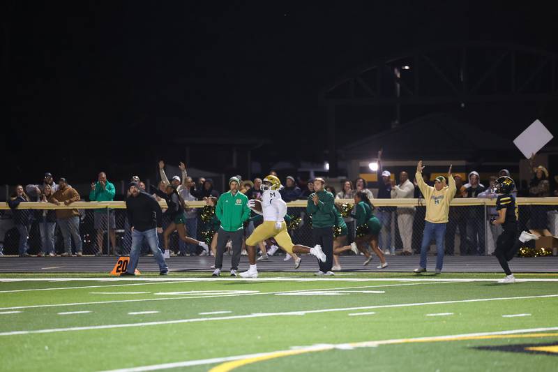 Bishop McNamara's Julius May breaks away from Herscher defenders for an 87-yard touchdown to secure a 38-28 lead near the end of the fourth quarter during the Fightin' Irish's 45-28 victory over Herscher on Friday, Sept. 5, 2025.
