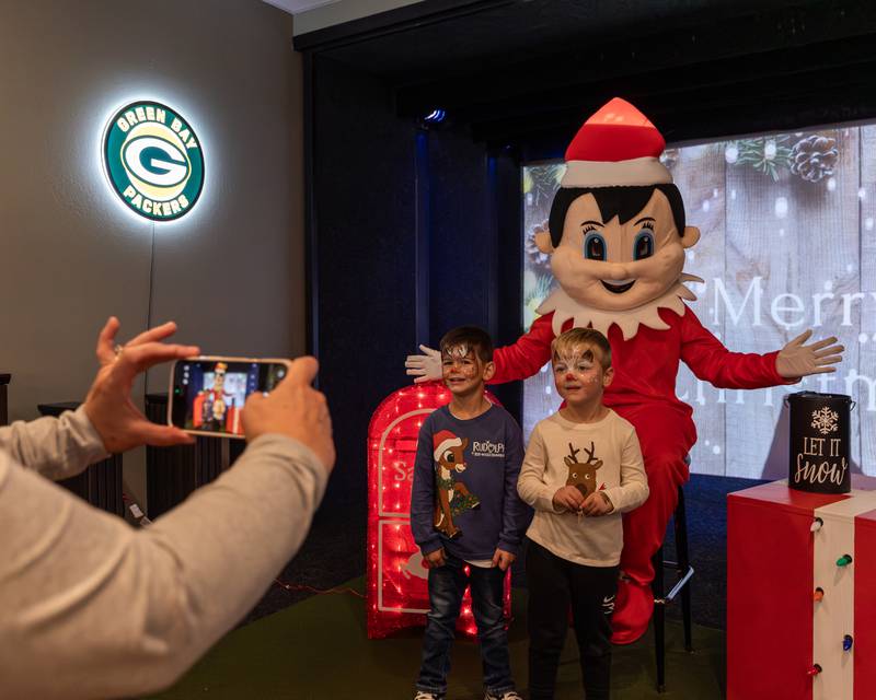 (from left) Levi Pyszka and Riley Waynick pose for photo with Elf at the annual Christmas in the Valley on Saturday, November 15, 2025 at the Tee Box in Spring Valley.
