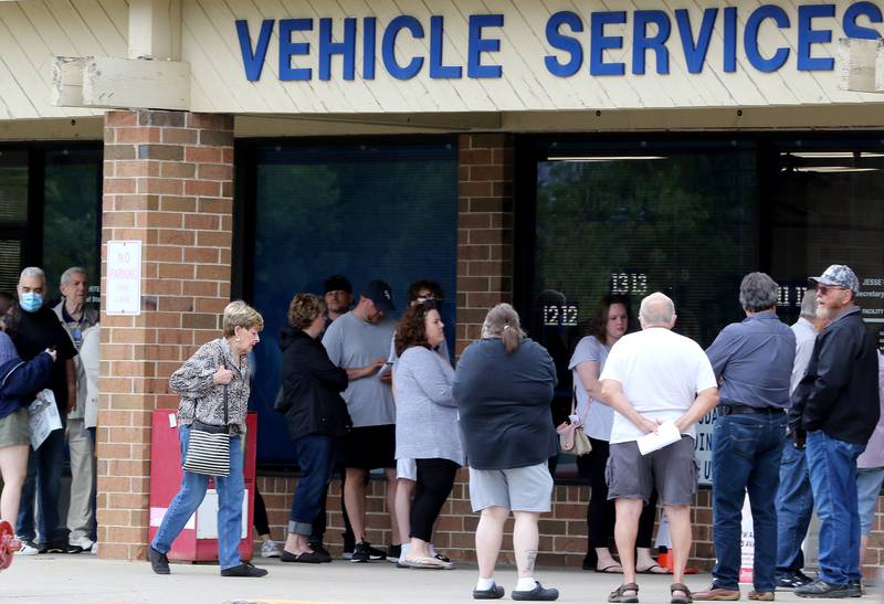 Motorists wait outside the Secretary of State office on Wednesday, June 23, 2021 in Woodstock.