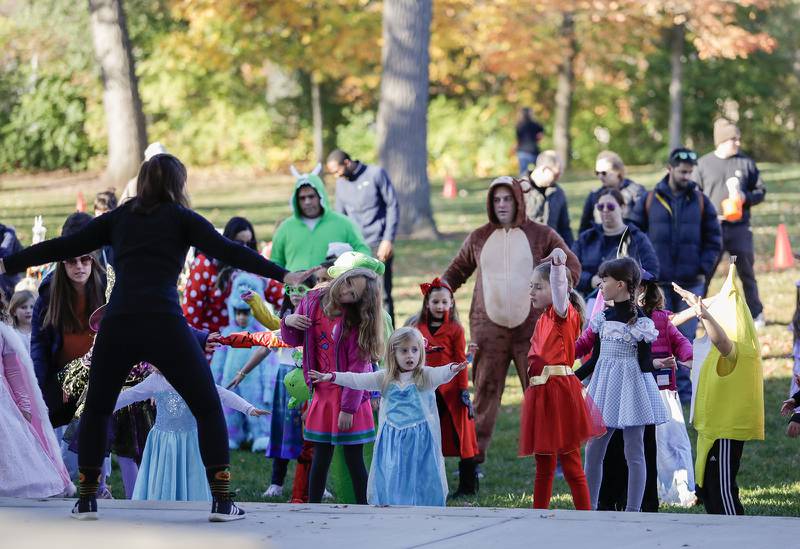 Aimee Frost teaches kids a dance routine during the Monster Mash Dance Party at Fishel Park in Downers Grove, Ill. on Saturday, October 29, 2022.