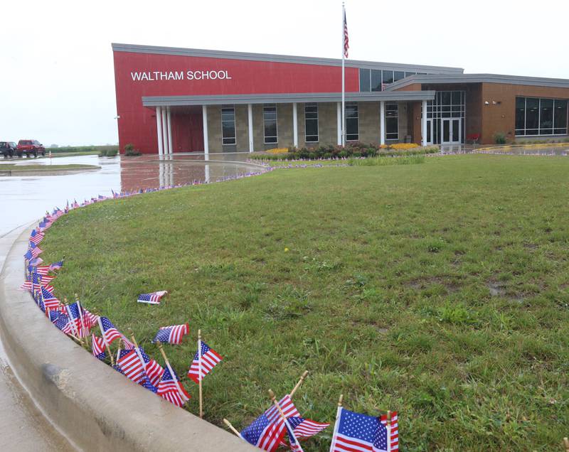 2,977 flags are placed outside Waltham School to remember the lives lost in the 9/11 attacks on Monday, Sept. 11, 2023 in Utica.