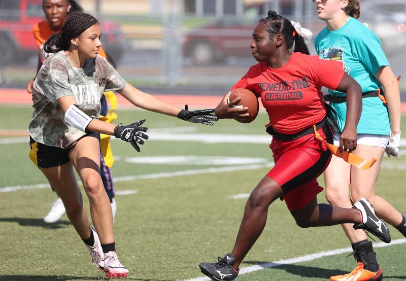 A player tries to avoid a defender Wednesday, Aug. 20, 2025, during the first practice of the DeKalb High School flag football team. The squad is preparing for their inaugural season.