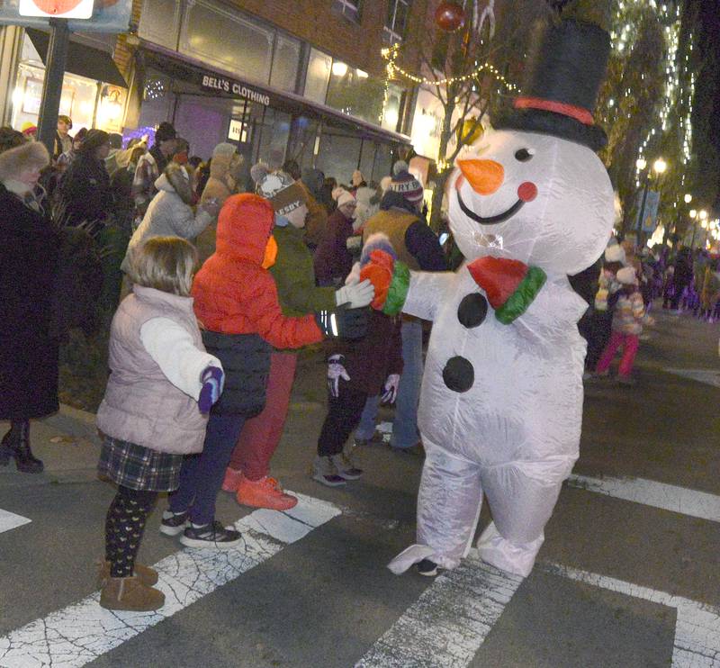 A friendly snowman greets he crowd gathered along La Salle St in Ottawa Friday during the Festival of Lights Parade.