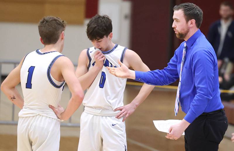 Hinckley-Big Rock's head coach Seth Sanderson talks to Tyler Smith (left) and Landon Roop Wednesday, March 1, 2023, during their Class 1A sectional semifinal matchup with Chicago Marshall at Elgin High School.
