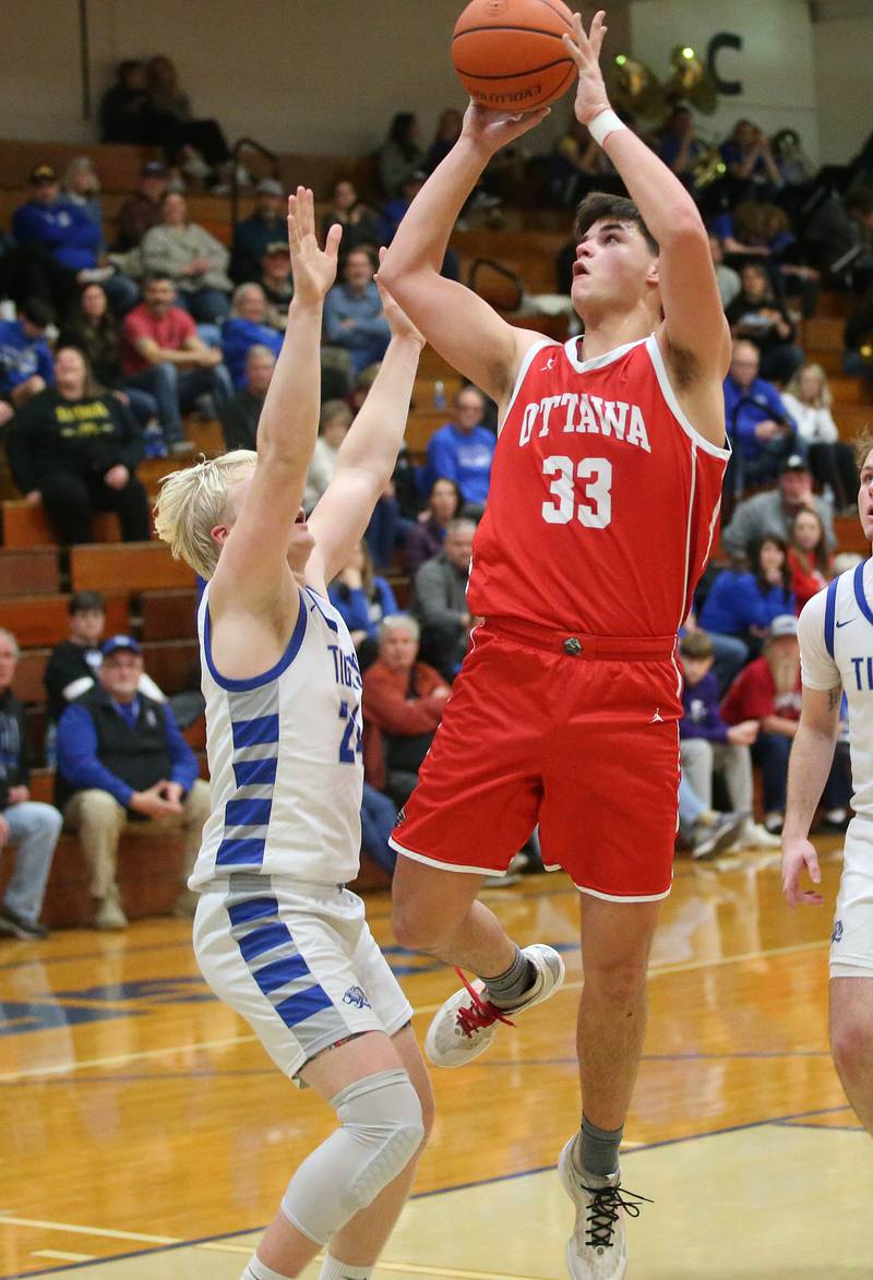 Ottawa's Cooper Knoll eyes the hoop as Princeton's Daniel Sousa defends on Monday, Feb. 5, 2024 at Prouty Gym.