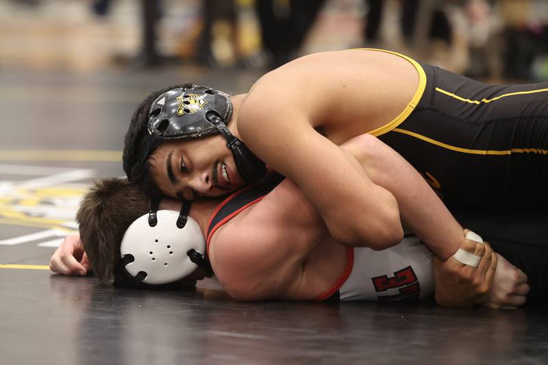 Adrian Hernandez of Joliet West works over Vincent Konecki of Yorkville in the 132-pound weight SPC Conference championship match at Joliet West on Saturday, Jan 25, 2025.