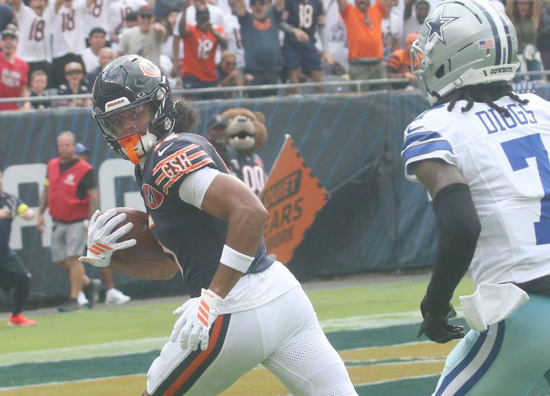 Chicago Bears wide receiver Rome Odunze looks back at Dallas Cowboys's corner back Trevon Digs as he runs into the end zone to score a touchdown on Sunday, Sept. 21, 2025 at Soldier Field.