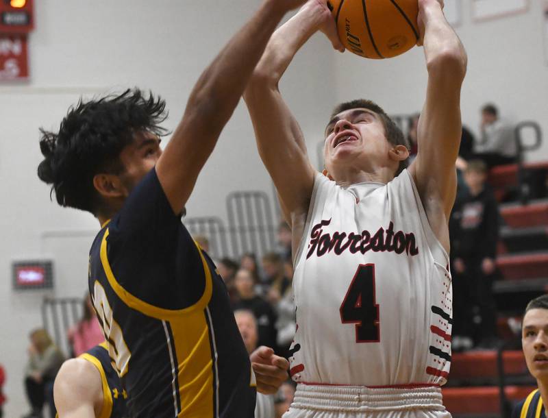 Forreston's Brady Gill (4) and Polo's Esteban Salinas (10)  battle for a rebounds on Saturday, Dec. 13, 2025 at the 64th Annual Forreston Holiday Basketball Tournament held at Forreston High School