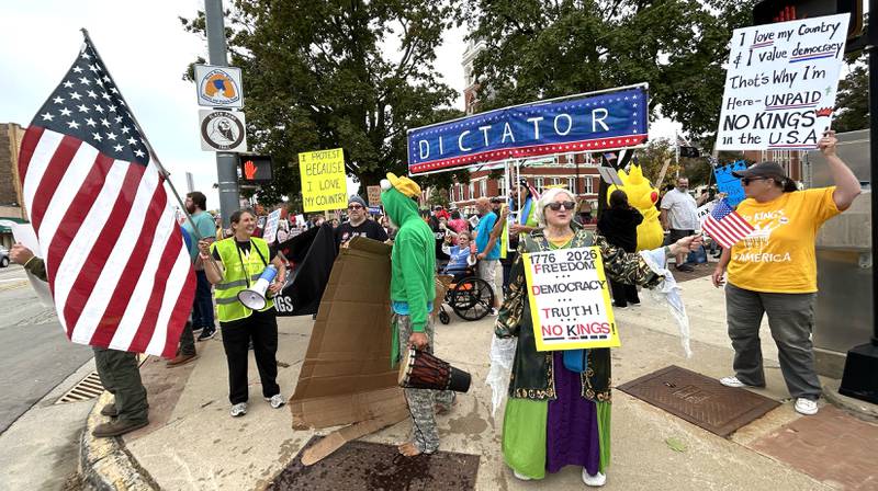 Signs and American flags were carried by demonstrators on Saturday, Oct. 18, 2025 at the No Kings rally on the Ogle County Courthouse square in Oregon, Illinois.