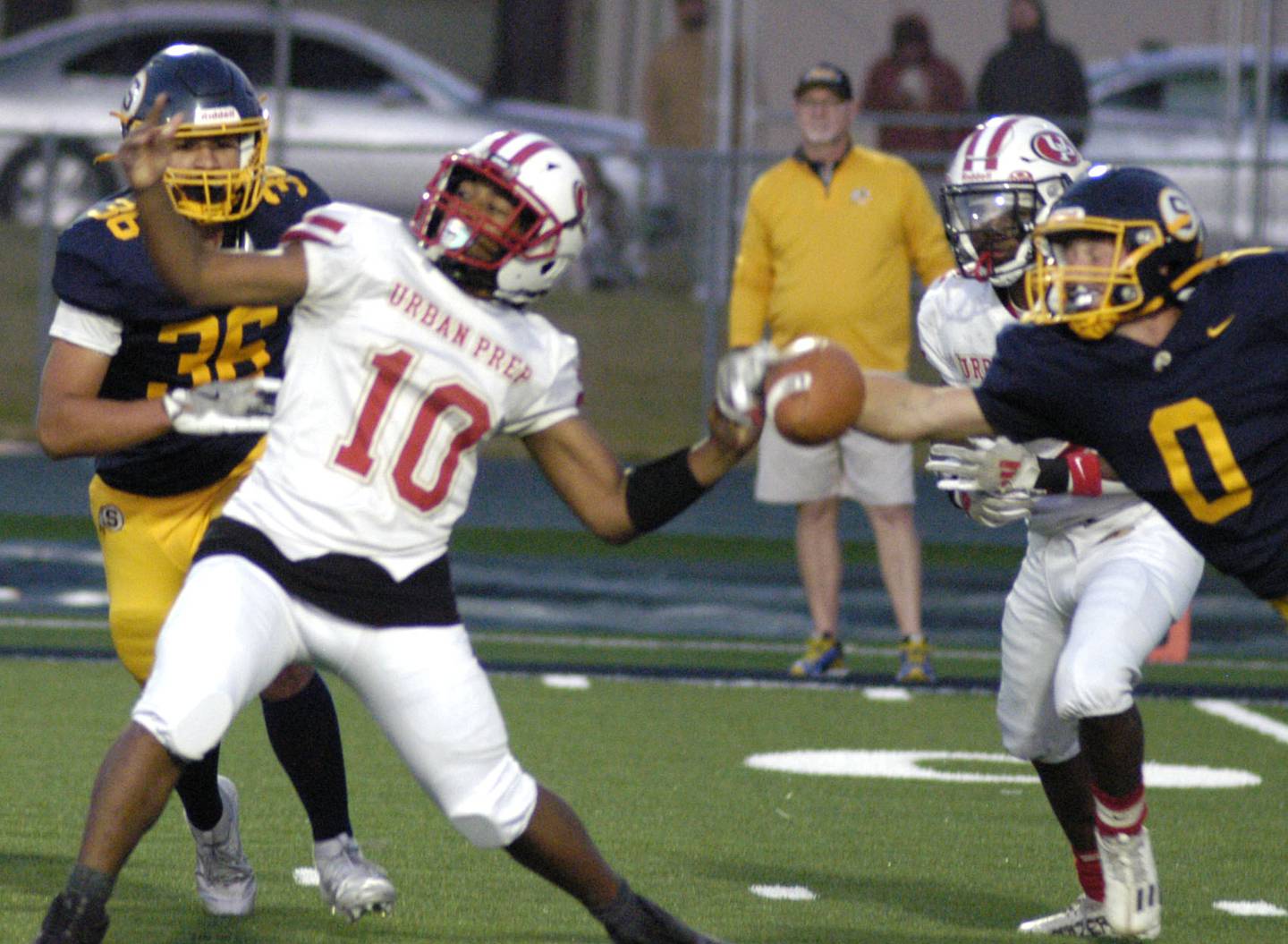 Urban's Rylan Campbell has the ball grabbed by Sterling's Wyatt Cassens. The Lions of Urban Prep traveled to Sterling to take on the Warriors at Prescott Memorial Field at Roscoe Eades Stadium, September 5, 2025.