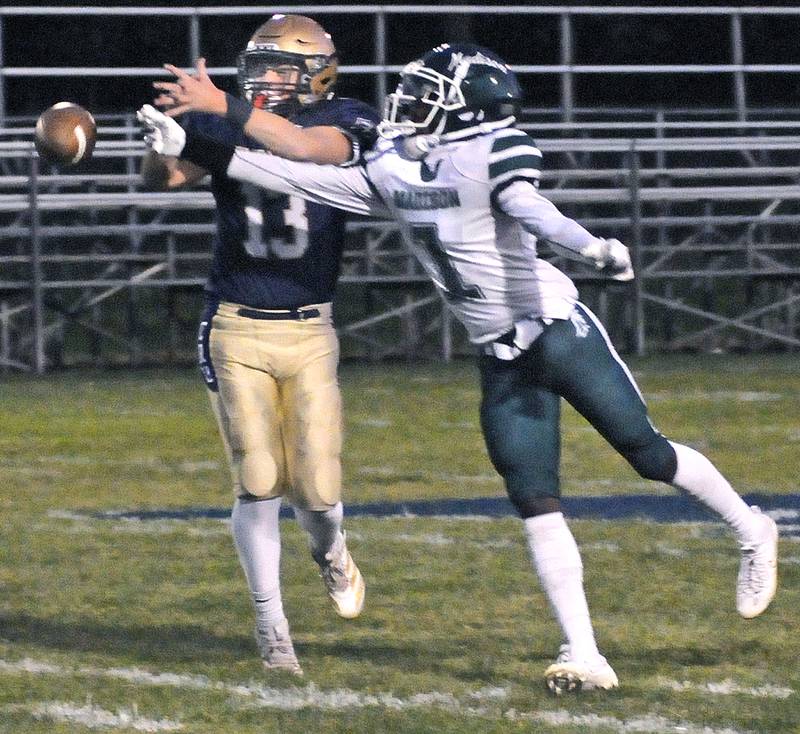 Marquette’s Ben Walker breaks up a Madison pass intended for TJ Wilbourn in the 1st quarter Friday at Marquette.