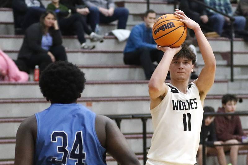 Prairie Ridge's Elijah Loeding shoots the ball over Illinois Math & Science Academy's Lota Onwuameze during a IHSA Class 3A Burlington Central Regional quarterfinal boys basketball game on Monday, feb23, 20256, at Prairie Ridge High School in Crystal Lake.