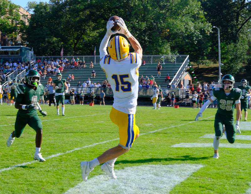 Lyons Township’s Grant Smith (15) goes up for a touchdown catch during a game on September 27, 2025 at Glenbard West High School in Glen Ellyn.