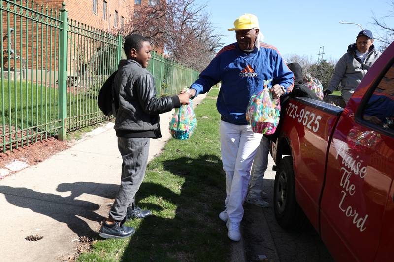 Ja’vonne Campbell, 8, gets an Easter basket from Roger Gates. For years Roger Gates has been giving out easter baskets in the community. Saturday, April 16, 2022, in Joliet.