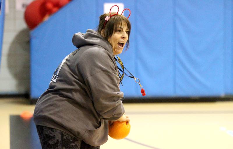 Physical education teacher Christine Giunta-Mayer laughs and dances with her students at St. Petronille Catholic School in Glen Ellyn.