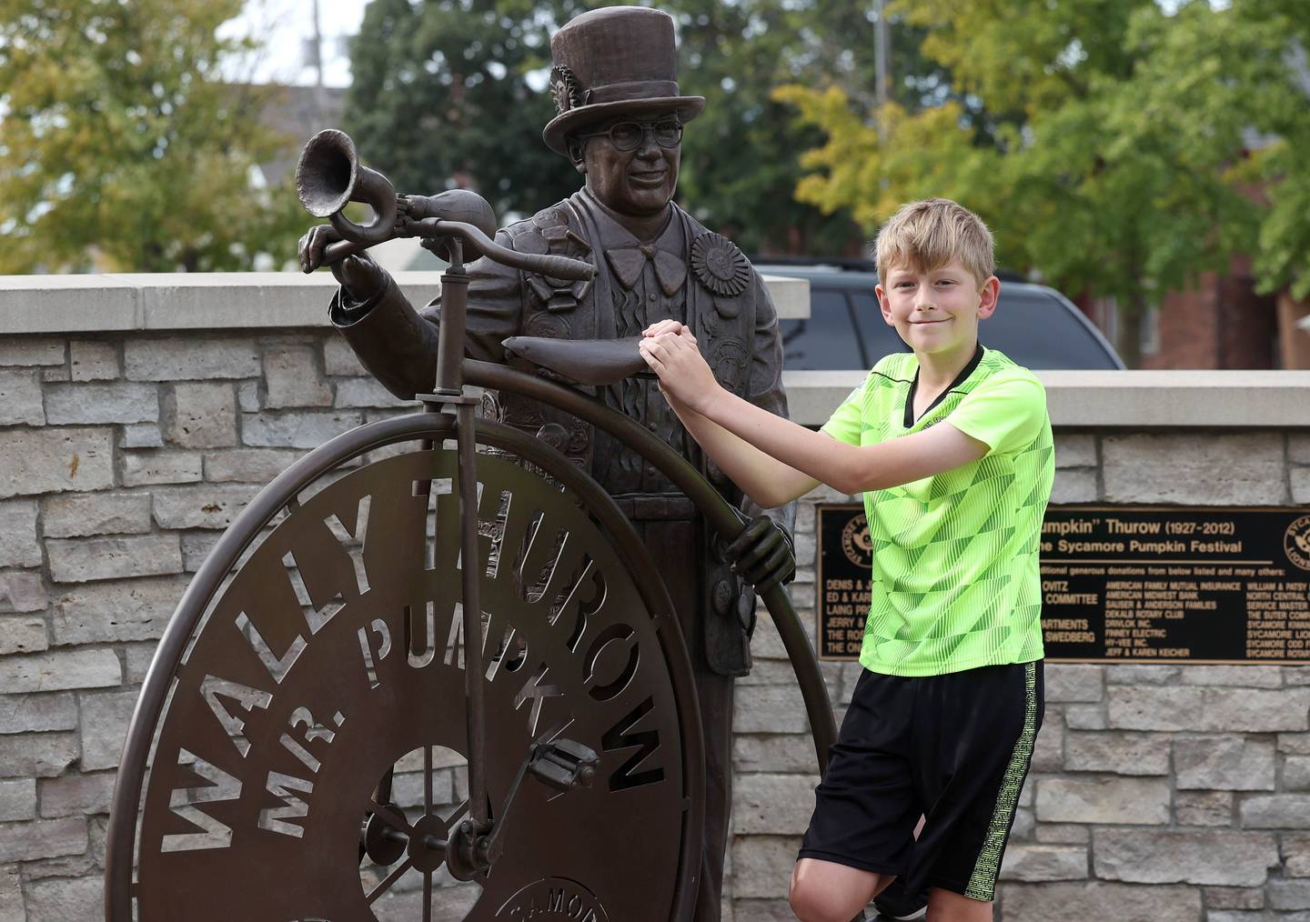 Sam Schwartz, 10, a fifth grader from North Grove Elementary School in Sycamore, with the Wally Thurow statue Friday Sept. 27, 2024, in Sycamore. Schwartz was the theme contest winner for the 2024 Sycamore Pumpkin Festival.