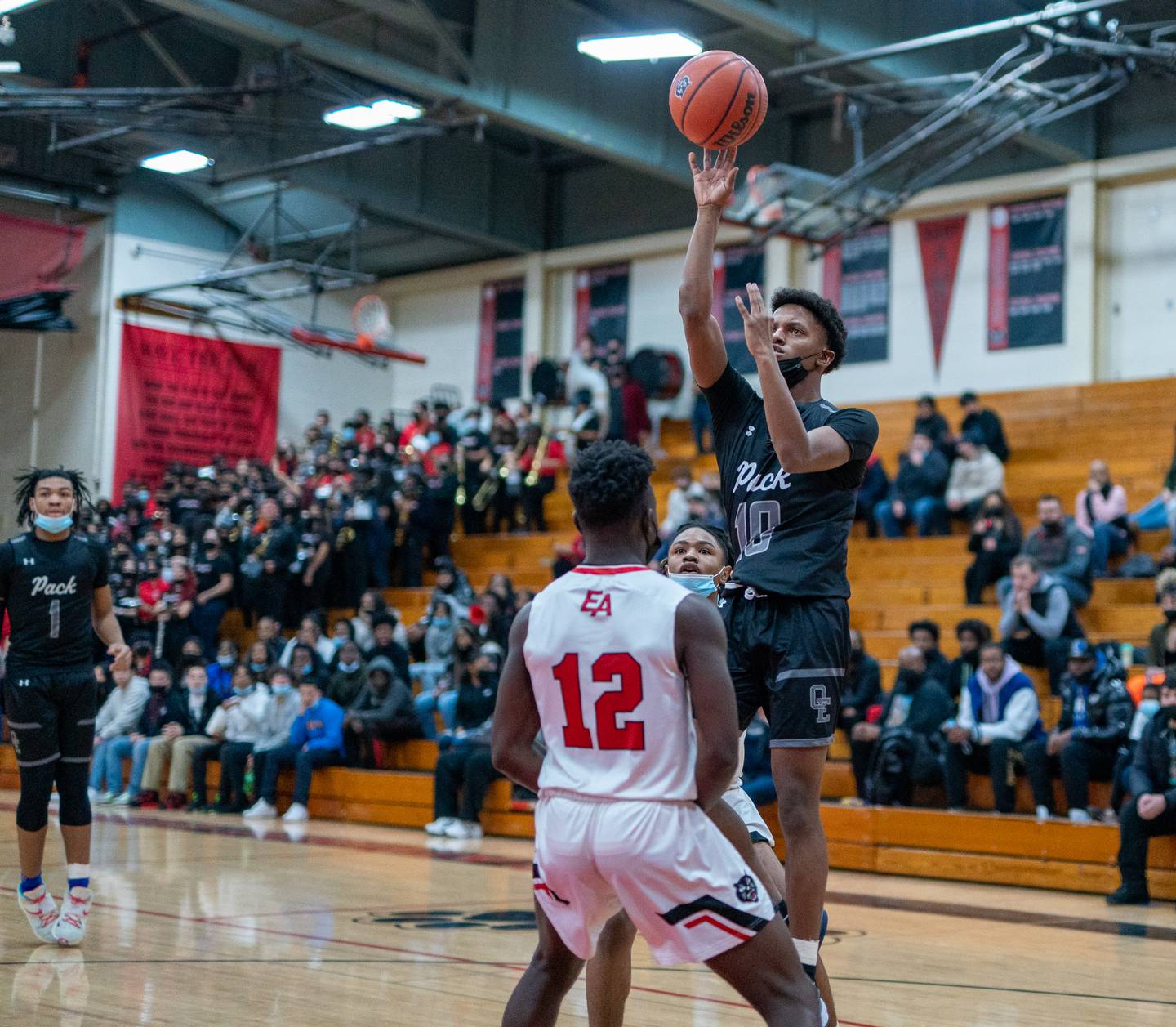 Oswego East's DeVon Oregon (10) shoots a floater over East Aurora's Ralph Clark (12) during the 11th Annual Kivisto Hoopfest at East Aurora on Saturday, Feb 5, 2022.