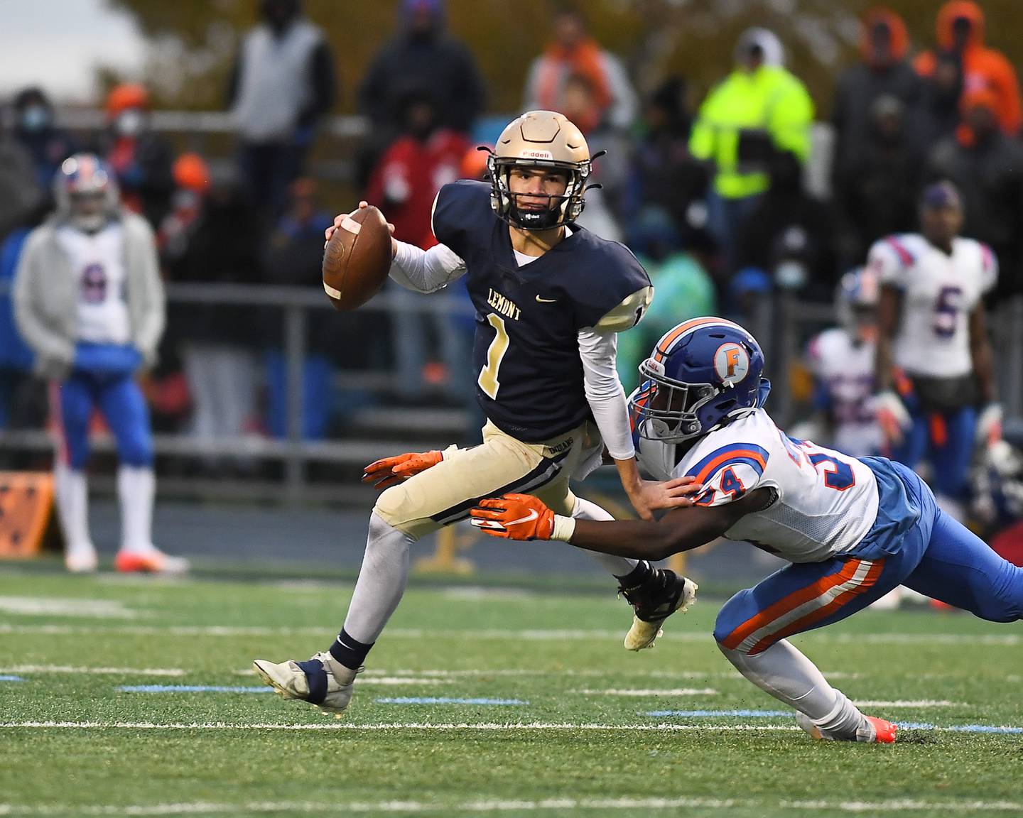 Lemont's Payton Salomon (1) scrambles to avoid the sack during Class 6A quarterfinal playoff game on Saturday, Nov. 13, 2021, at Lemont High School.