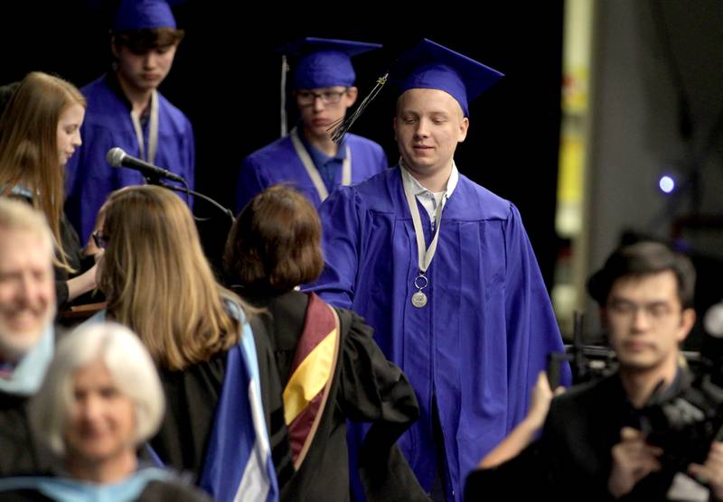 St. Charles North graduate Will Newman crosses the stage during the school’s 2023 commencement ceremony at Northern Illinois University in DeKalb on Monday, May 22, 2023.
