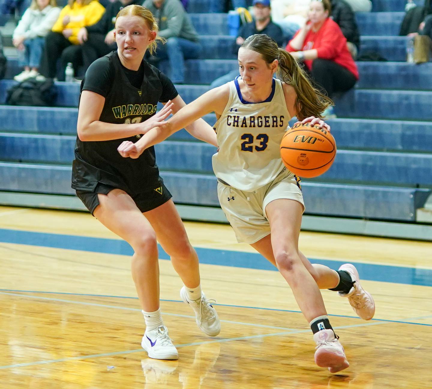 Aurora Central Catholic's Riley Cwinski (right), drives to the basket against Waubonsie Valley's Lily Newton during a basketball game at Aurora Central Catholic High School on Thursday, January 30, 2025.