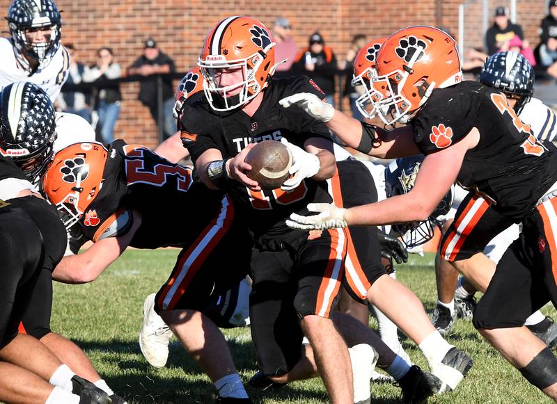 Byron quarterback Andrew Talbert (16) hands the ball off to Caden Considine (37) against Elmhurst IC Catholic during 3A quarterfinals at Byron High School on Saturday, Nov. 15, 2025.