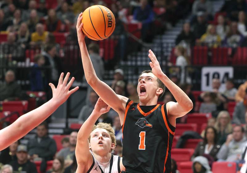 DeKalb's Jackson Kees goes to the basket ahead of Sycamore's Isaiah Feuerbach during their game Friday, Jan. 31, 2025, in the FNBO Challenge in the Convocation Center at Northern Illinois University in DeKalb.