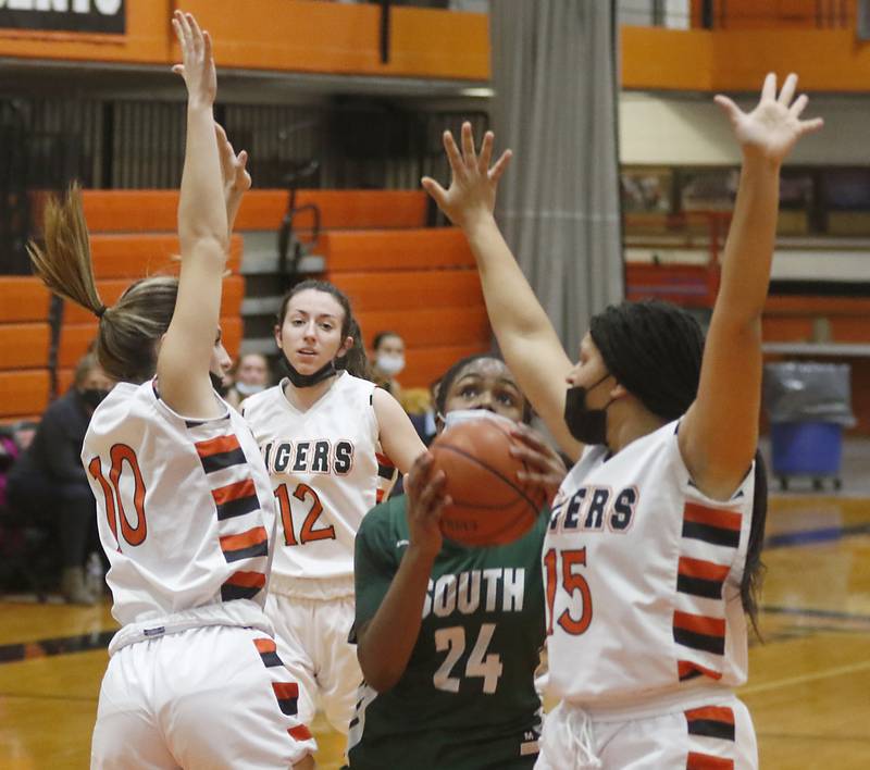Crystal Lake South's Kree Nunnally shoots the ball between Crystal Lake Central's Isabelle Szela, left, and Taja Bryan, right, during a Fox Valley Conference basketball game Wednesday, Jan. 26, 2022, between Crystal Lake South and Crystal Lake Central at Crystal Lake Central High School.