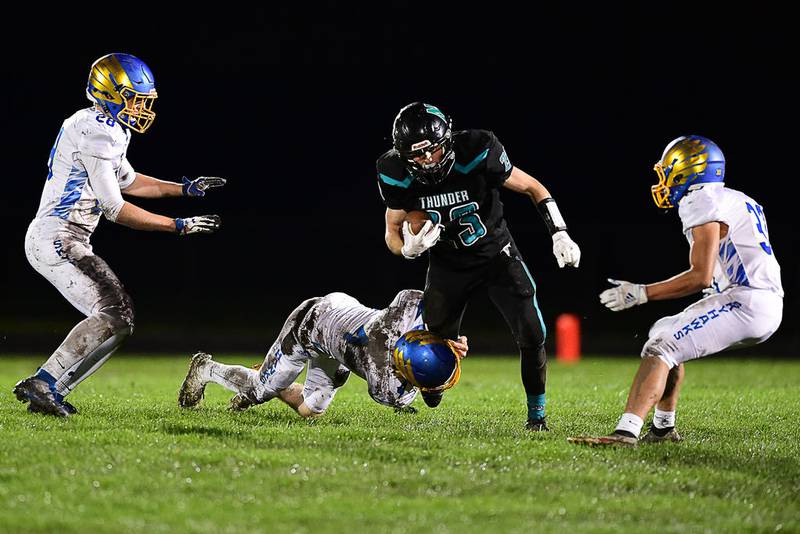 Woodstock North running back Colin Zinn tries to escape from three Johnsburg defenders Friday in Woodstock. Zinn scored four touchdowns on offense and also had two interceptions on defense.