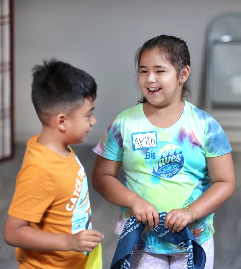 Ayden Lythcke, (left) 7, from Sycamore, and Aylin Salazar, 7, from DeKalb, have a laugh Monday, July 11, 2022, during a session of Summer Reading Vacation put on by Neighbors' House in DeKalb in conjunction with the DeKalb County Farm Bureau. Christ Community Church is hosting the camp this week in their outreach center on North 6th Street in DeKalb.