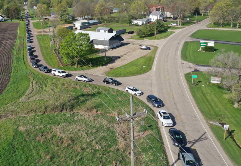 A long line of cars stretching a half-mile long waits to drop off electronics during a free electronics recycling drive on Saturday, April 26, 2025 at the Bureau County Highway Department in Princeton.