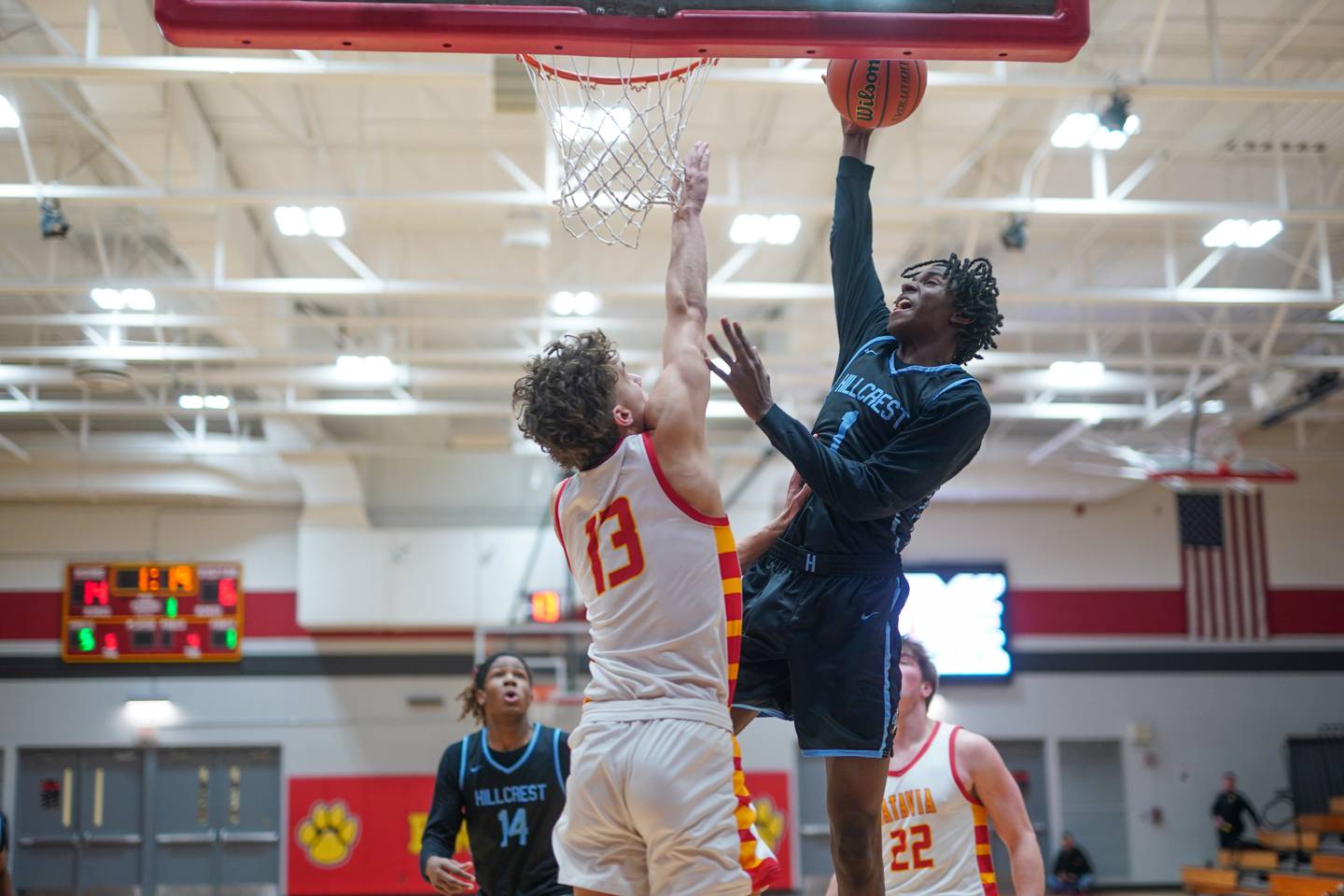 Hillcrest's Adam Page (1) drives to the hoop against Batavia’s Isaac Wit (13) during the 30th annual Jim & Silvia Roberts Night of Hoops at Batavia High School on Saturday, Jan 20, 2024.