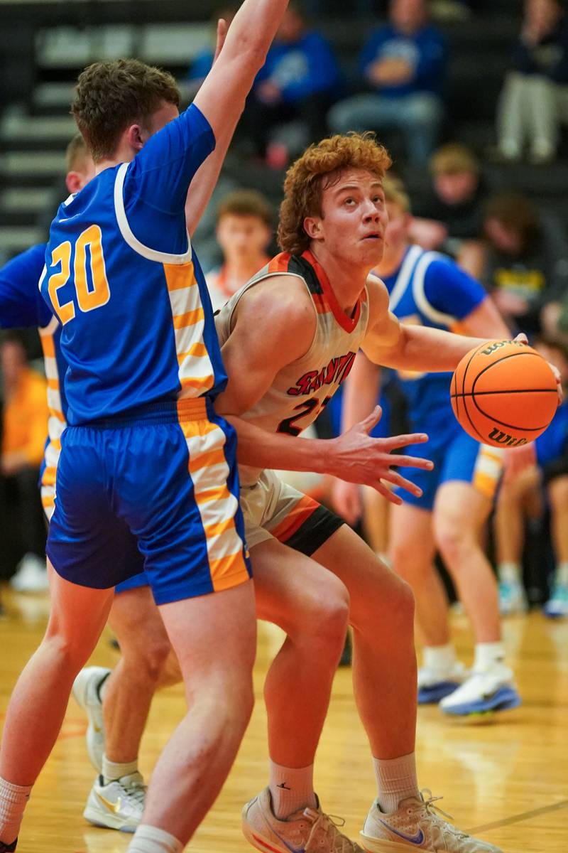 Sandwich’s Dom Rome (22) plays the ball in the post against Johnsburg's Joshua Kaunas (20) during a basketball game at Sandwich High School on Friday, January 31, 2025.