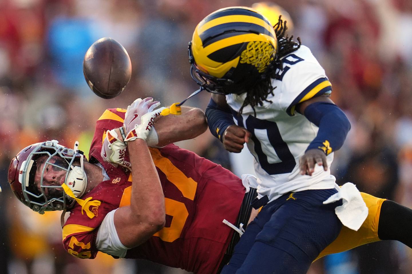 Southern California tight end Lake McRee (87) fumbles as he is hit by Michigan defensive back Jyaire Hill (20) during the first half of an NCAA college football game at USC this season.