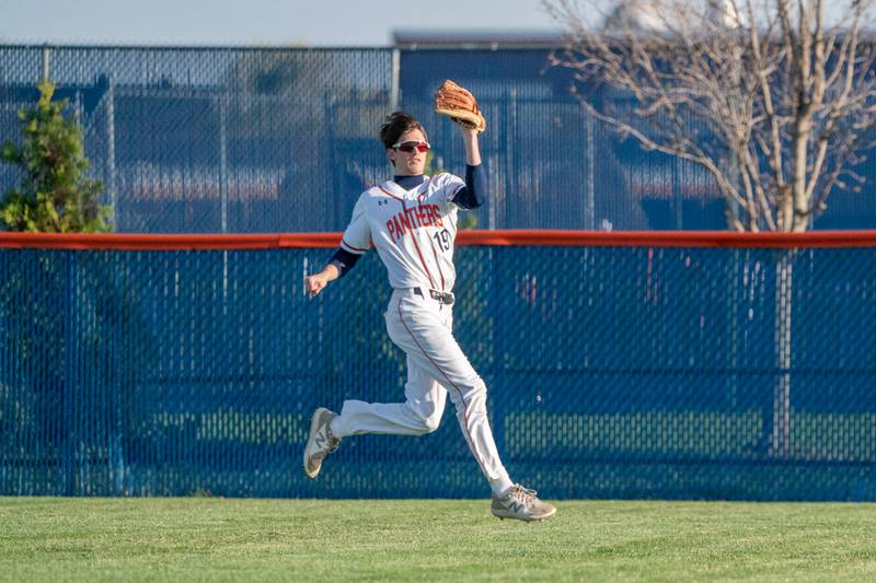 Oswego’s Luke Voelker (19) makes a catch in the outfield against Minooka during a baseball game at Oswego High School on Tuesday, April 18, 2023.
