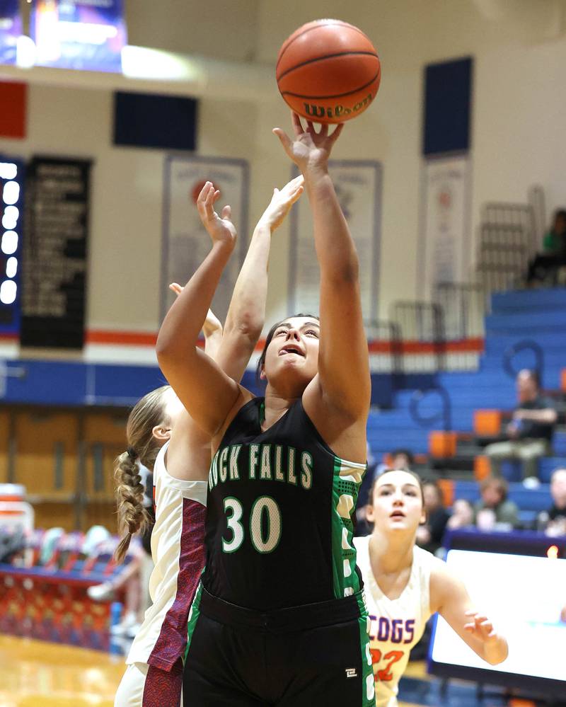 Rock Falls' Taylor Reyna gets a shot up in front of Genoa-Kingston's Arielle Rich during their game Friday, Feb. 2, 2024, at Genoa-Kingston High School.