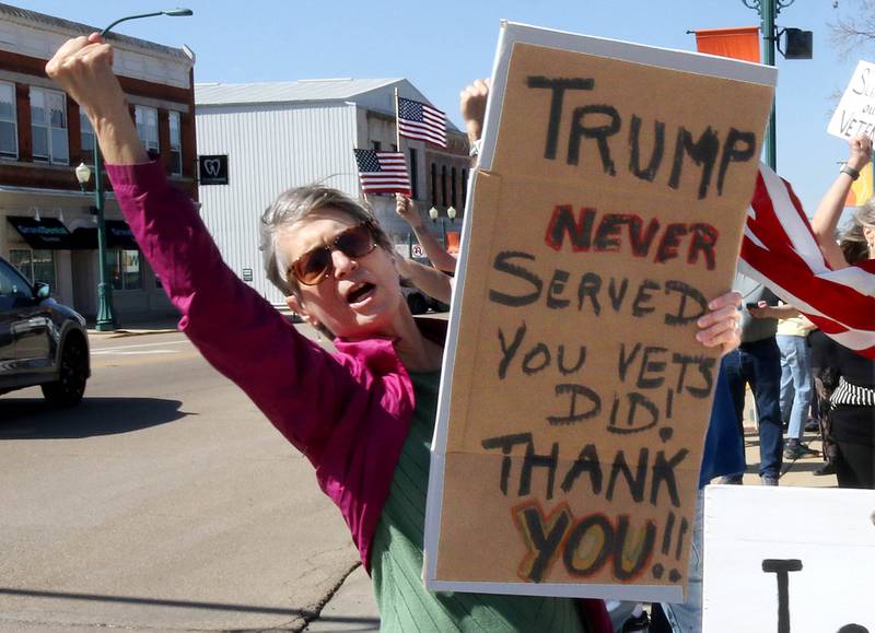 Protesters cheer on honking cars as they voice their displeasure with President Donald Trump Friday, March 14, 2025, in front of the DeKalb County Courthouse in Sycamore. The group was protesting recent cuts by the Trump administration to the Department of Veterans Affairs.