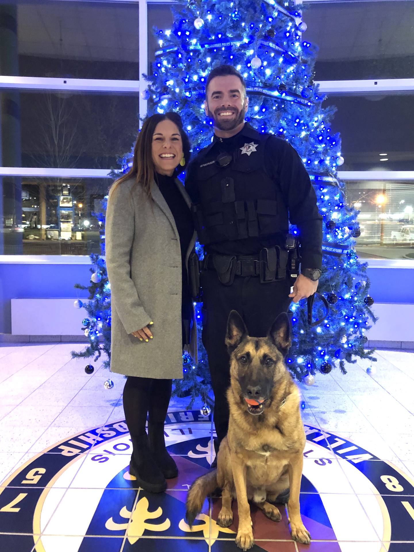 Bourbonnais Police Sgt. Dave Herberger and his wife, Emily LaVoie, stand with Herberger's K-9 partner Athos at the Bourbonnais Municipal Building.