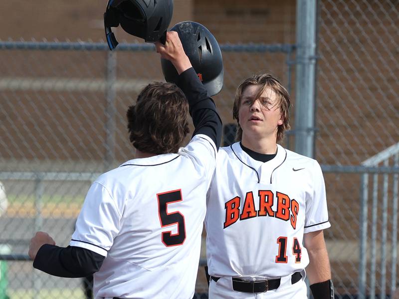 DeKalb's Cole Latimer is congratulated by Brodie Farrell after homering during their game against Neuqua Valley Tuesday, May 7, 2024, at DeKalb High School.