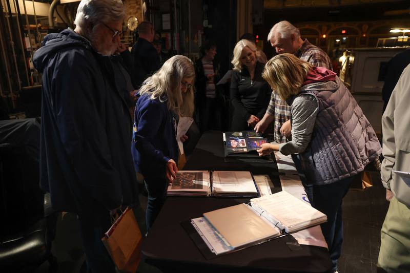 Guest look over albums with credentials and playbills at the Rialto Theater’s 100th anniversary celebration on Sunday, May 3, 2026 in Joliet.