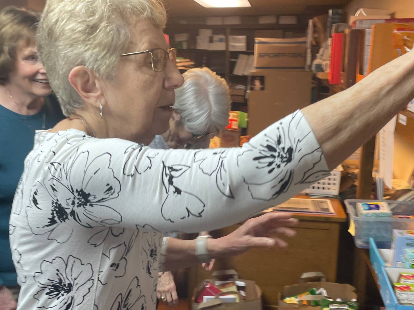 Kathy Rauh (foreground) of Peru has overseen the food pantry at the La Salle Catholic Parishes. Rauh was staggered by the homeless problem during a visit to San Francisco and was moved to assist those in need upon her return home.