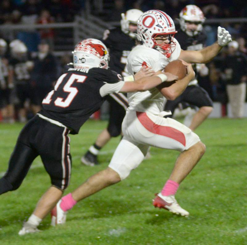 Oregon's Jakobi Donagen (4) runs for a gain as Stillman Valley's Tyler Kenyon reaches for the tackle during first half action on Friday, Oct. 10, 2025.