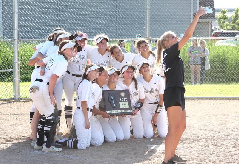 Kaneland players do a selfie with a coach after defeating Belvedere North Friday, June 3, 2022, in the IHSA Class 3A Sectional final game at Sycamore High School.