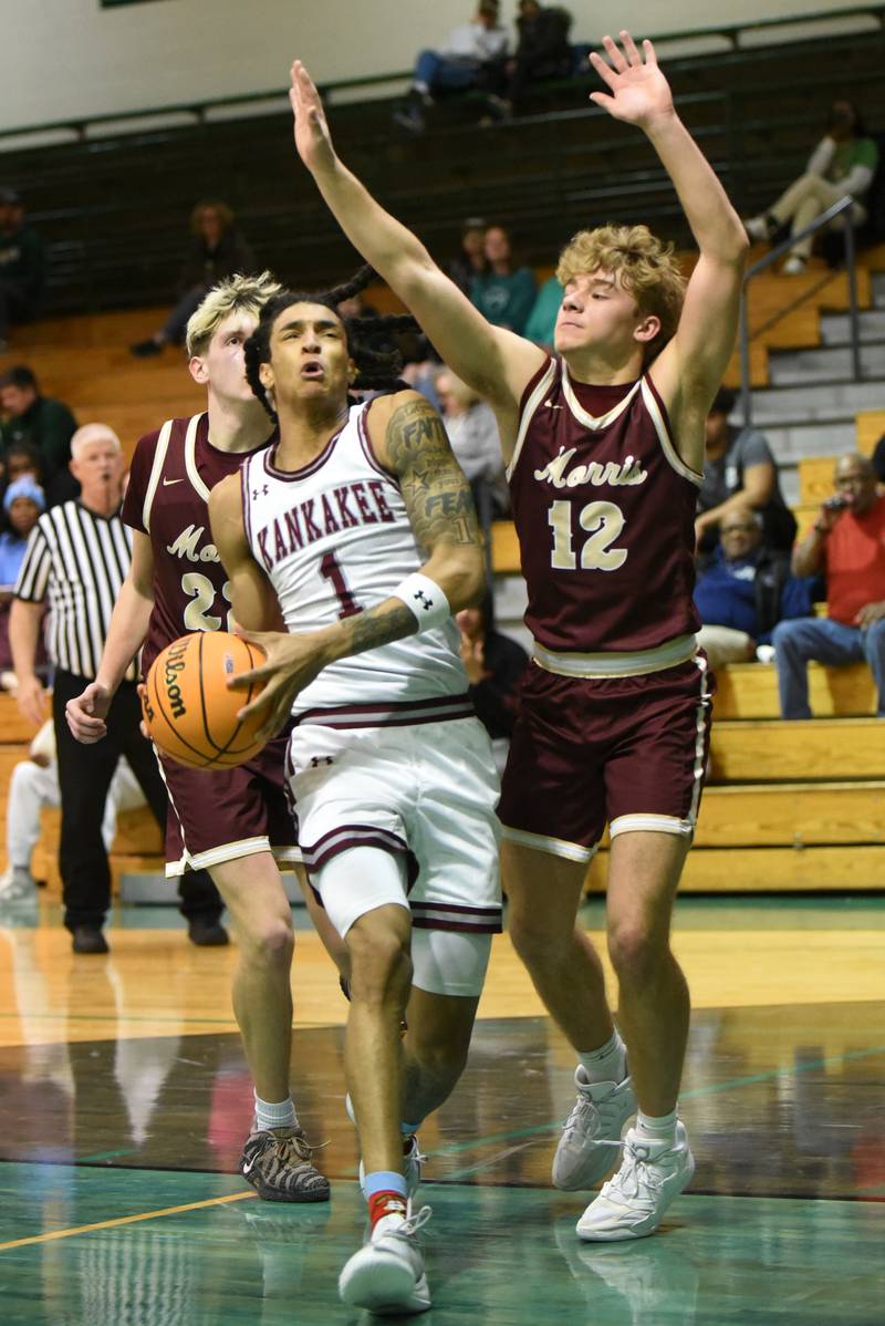 Kankakee's Lincoln Williams, left, drives past Morris' Caden Medler during the IHSA Class 3A Geneseo Regional semifinals Wednesday, Feb. 25, 2026.