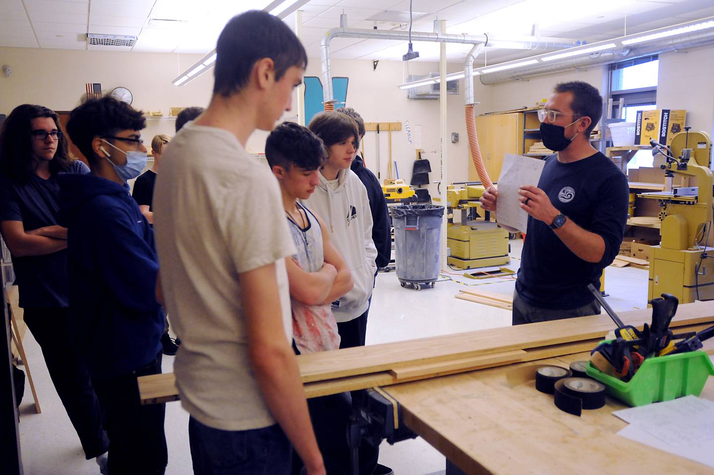 Teacher Brett Fankhauser teaches students in a wood shop class at Woodstock North High School about how to lay out a plan before the students make end tables Wednesday, March 23, 2022. Fankhauser also teaches at Woodstock High School.
