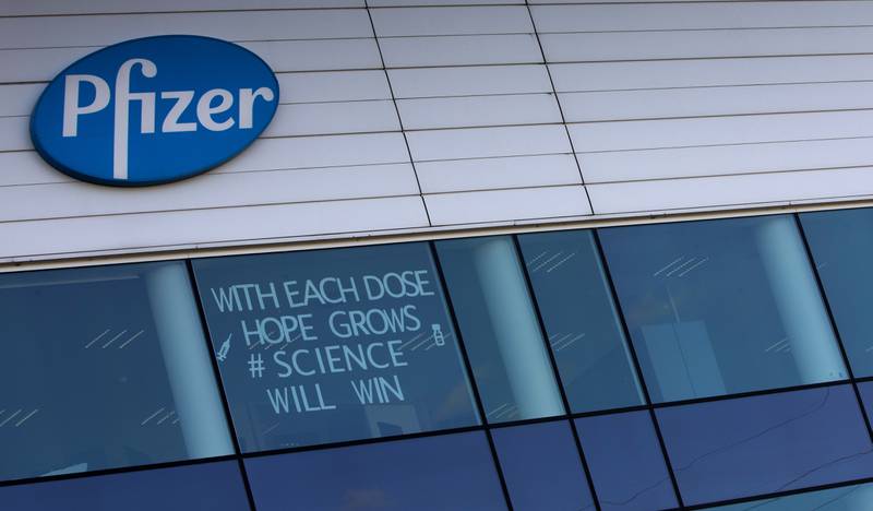 FILE - In this Tuesday, Feb. 23, 2021 file photo, a sign is pasted into an upper window at Pfizer manufacturing center in Puurs, Belgium. The European Union cemented its support for Pfizer-BioNTech and its novel COVID-19 vaccine technology, Saturday, May 8, 2021 by agreeing to a massive contract extension for a potential 1.8 billion doses through 2023. The new contract, which has the backing of the EU member states, will entail not only the production of the vaccines, but also making sure that all the essential components should be sourced from the EU. (AP Photo/Virginia Mayo, File)