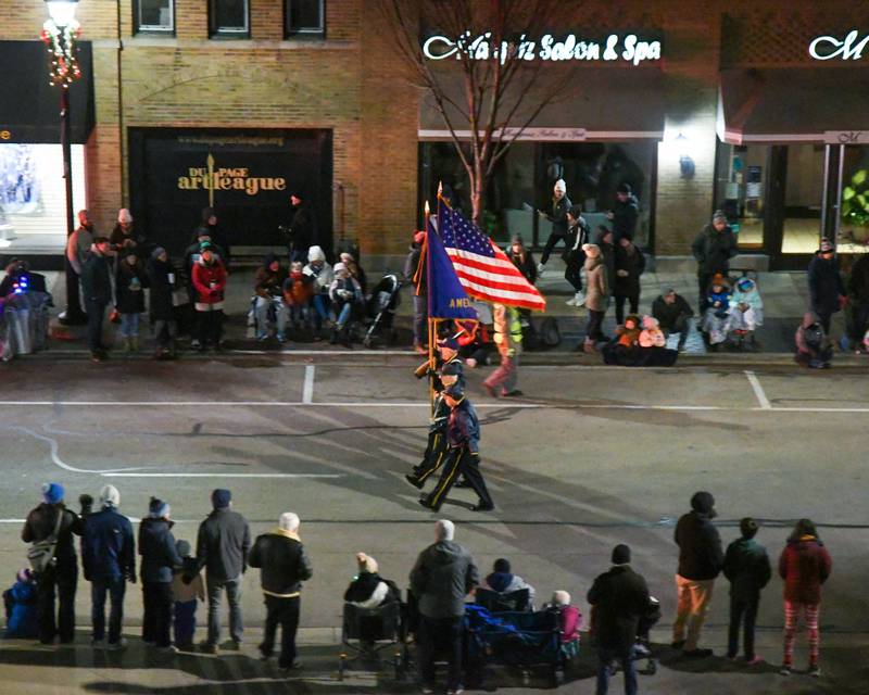 The American legion carries the American colors through the Wheaton Holiday Parade in downtown Wheaton held on Friday Nov. 24, 2023.