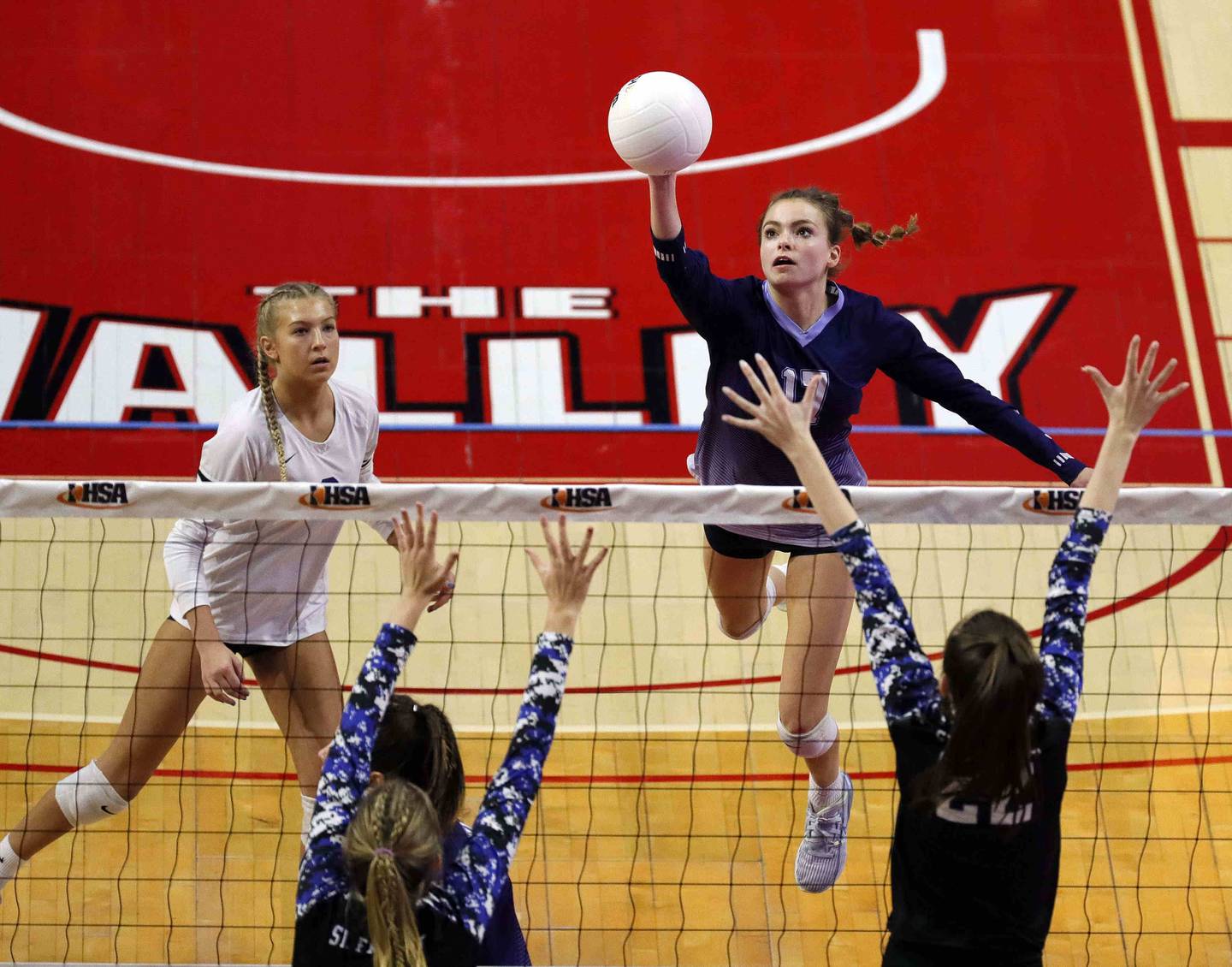 Nazareth Academy's Lauren Salata (17) tips the ball over the net during the IHSA Class 3A girls volleyball state championship game between St. Francis and Nazareth Academy Saturday November 12, 2022 at Redbird Arena in Normal.