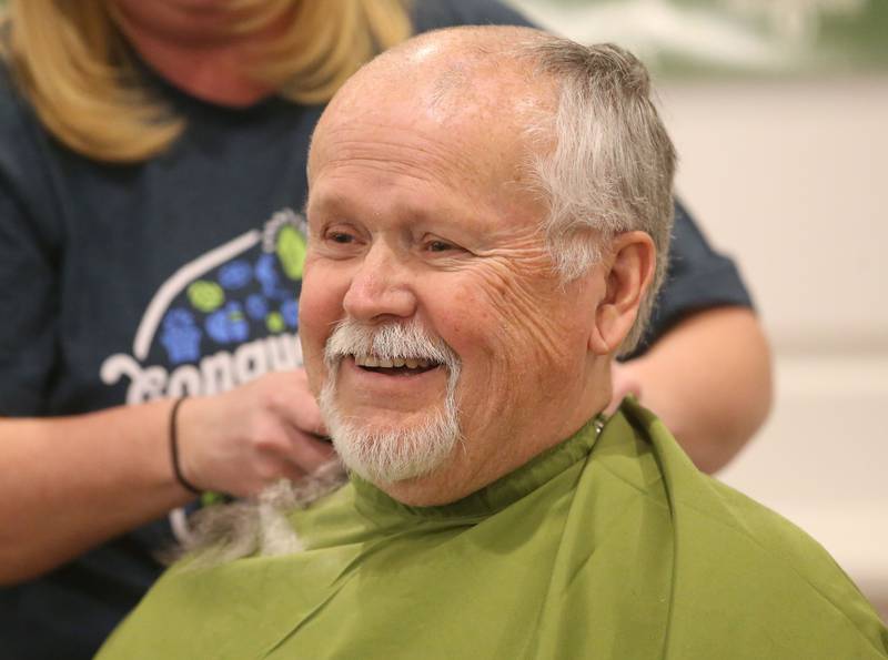 Utica firefighter Lisle Elsbury smiles while getting his head shaved during the 18th annual Illinois Valley Emergency Services St. Baldrick's event on Sunday, March 23, 2025 at Senicas Oak Ridge in La Salle.